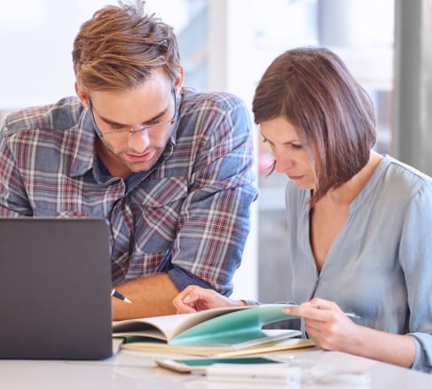 image of a male and female reviewing a Commercal Term-life Insurance policy while sitting in front of a computer in Columbia, SC