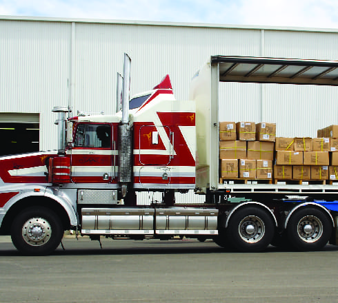 image of a parked truck carrying boxes insured byt Cotor Trcuk Cargo Insurance Columbia, SC